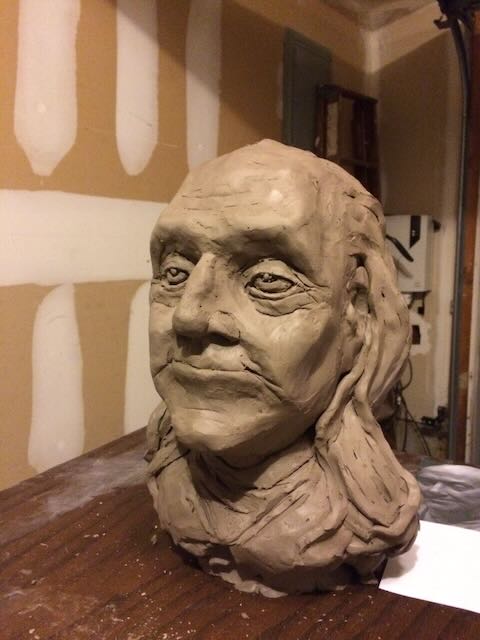 Sculpture bust of Ben Franklin made from clay, wood, and metal